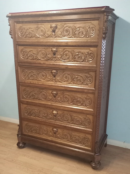 19th century Italian walnut chest of drawers with decorative floral carvings and ornamental feet