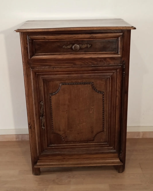 Vintage oak sideboard with drawer and door with dark wood carved panels