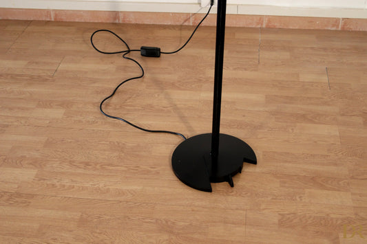 Black vintage floor lamp with minimalist design and circular base by award-winning duo perry floor lamp arteluce triana italian postmodernism