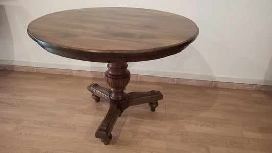 Round 19th century walnut table in vintage Umbertine style with carved base and light wood wheels