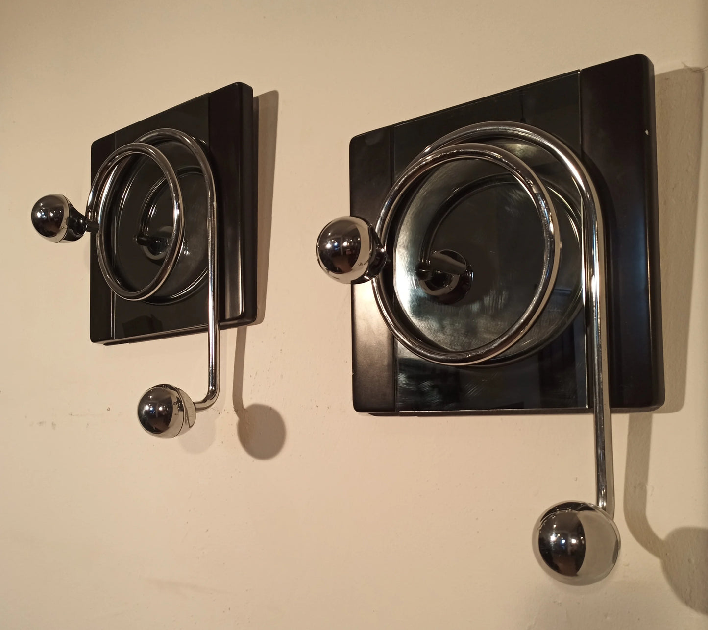 Two elegant black and chrome wall coat hooks designed by Willy Rizzo from the 1970s with circular shapes.