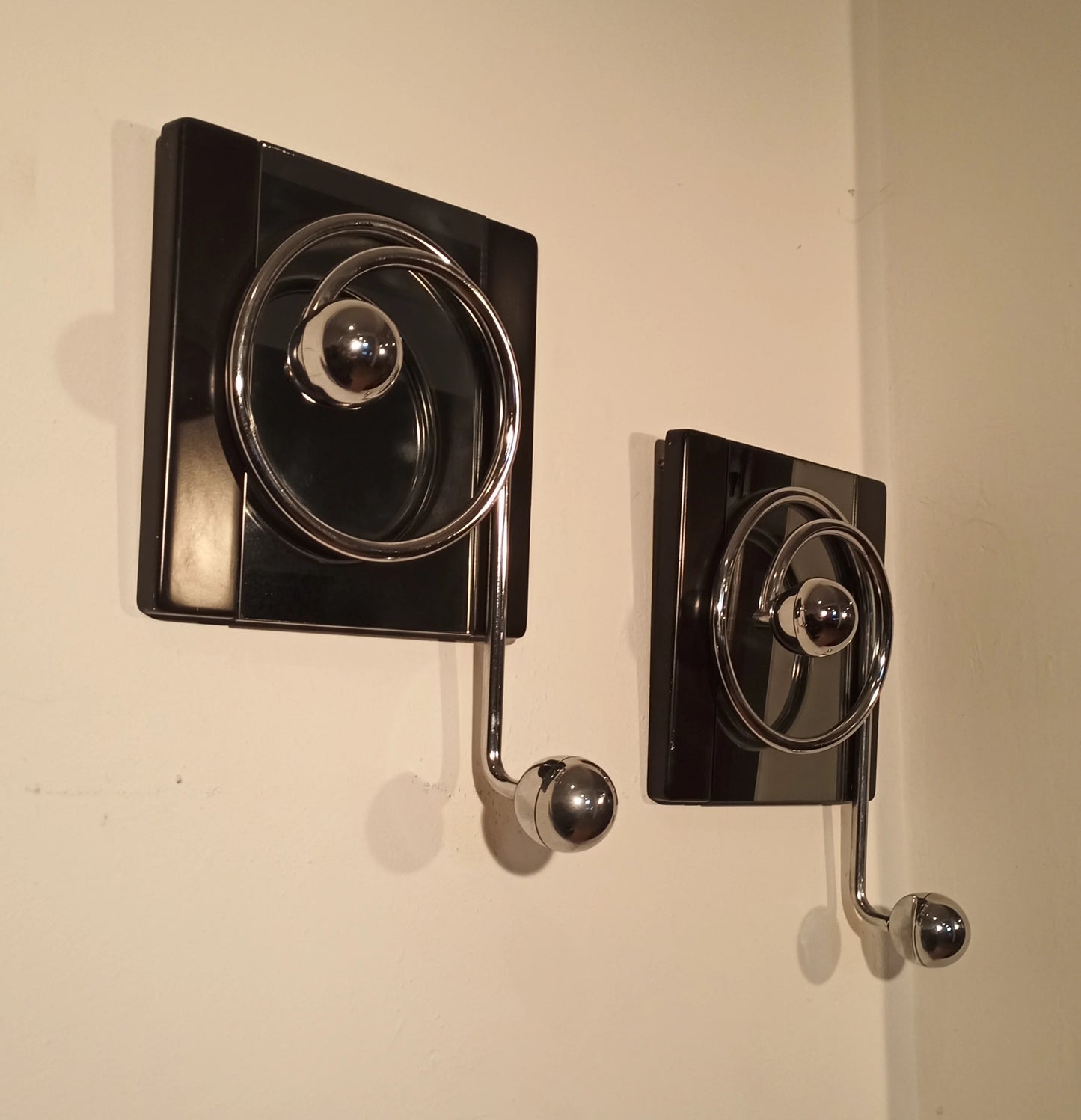 Two elegant black wall coat hooks with crank handles, designed by Willy Rizzo in the 1970s for Mario Sabot.