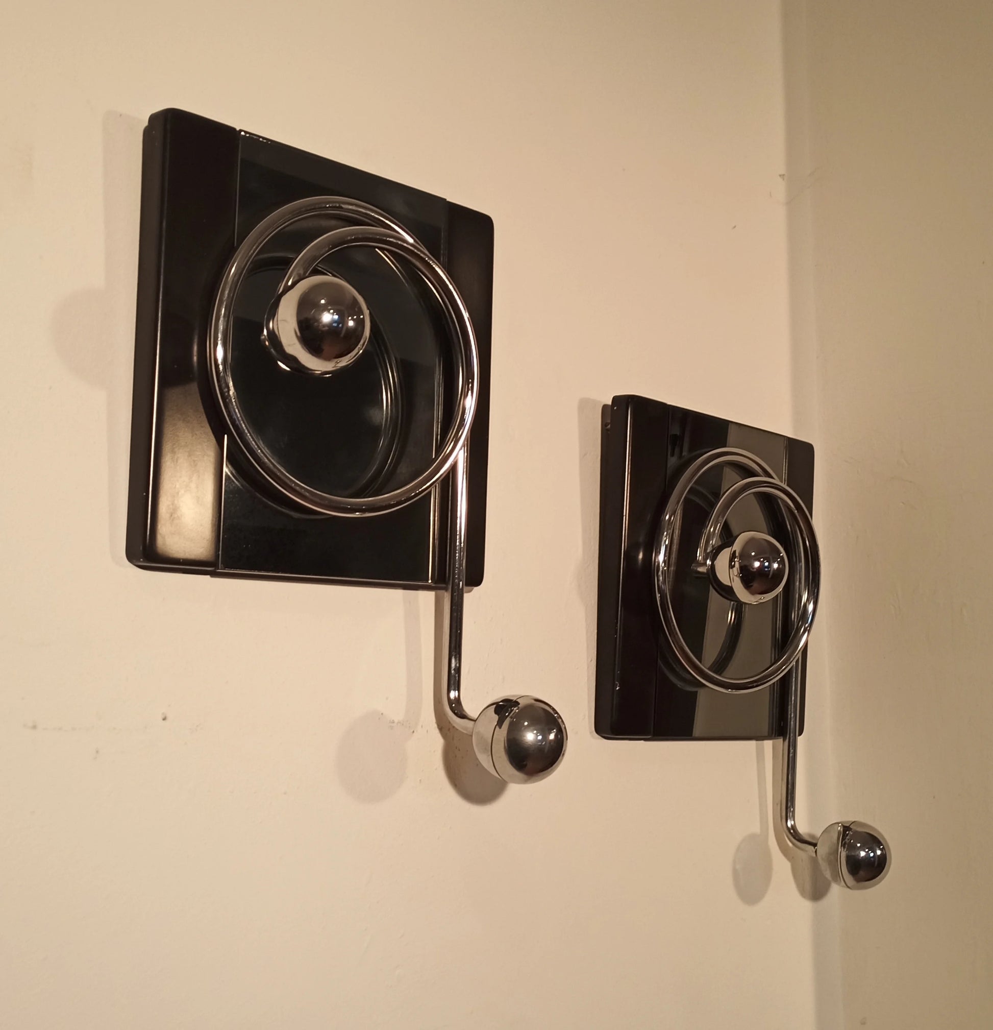 Two elegant black wall coat hooks with crank handles, designed by Willy Rizzo in the 1970s for Mario Sabot.