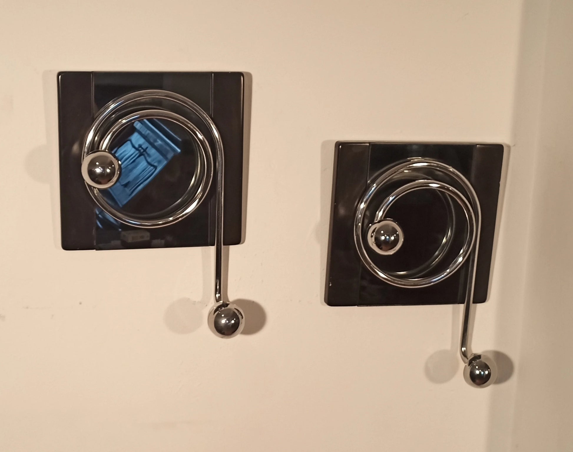 Pair of elegant black wall coat hooks with chrome spiral design by Willy Rizzo from the 1970s