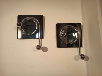 Two elegant black wall coat hooks with glass dome and metal arms, designed by Willy Rizzo in the 1970s.