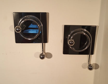 Pair of elegant black wall coat hooks with chrome details, designed by Willy Rizzo in the 1970s.