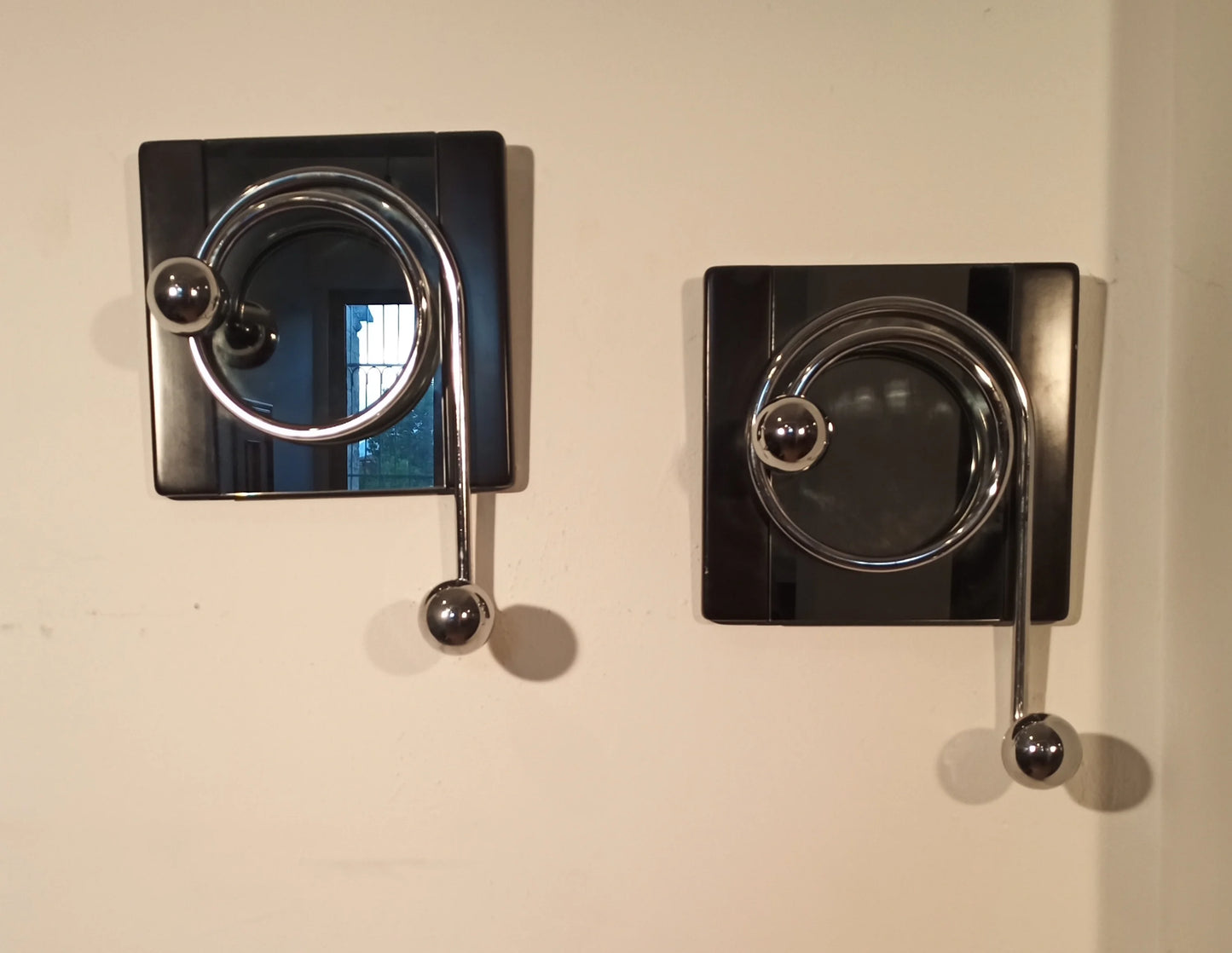 Two elegant black wall coat hooks with chrome accents, designed by Willy Rizzo in the 1970s for Mario Sabot.