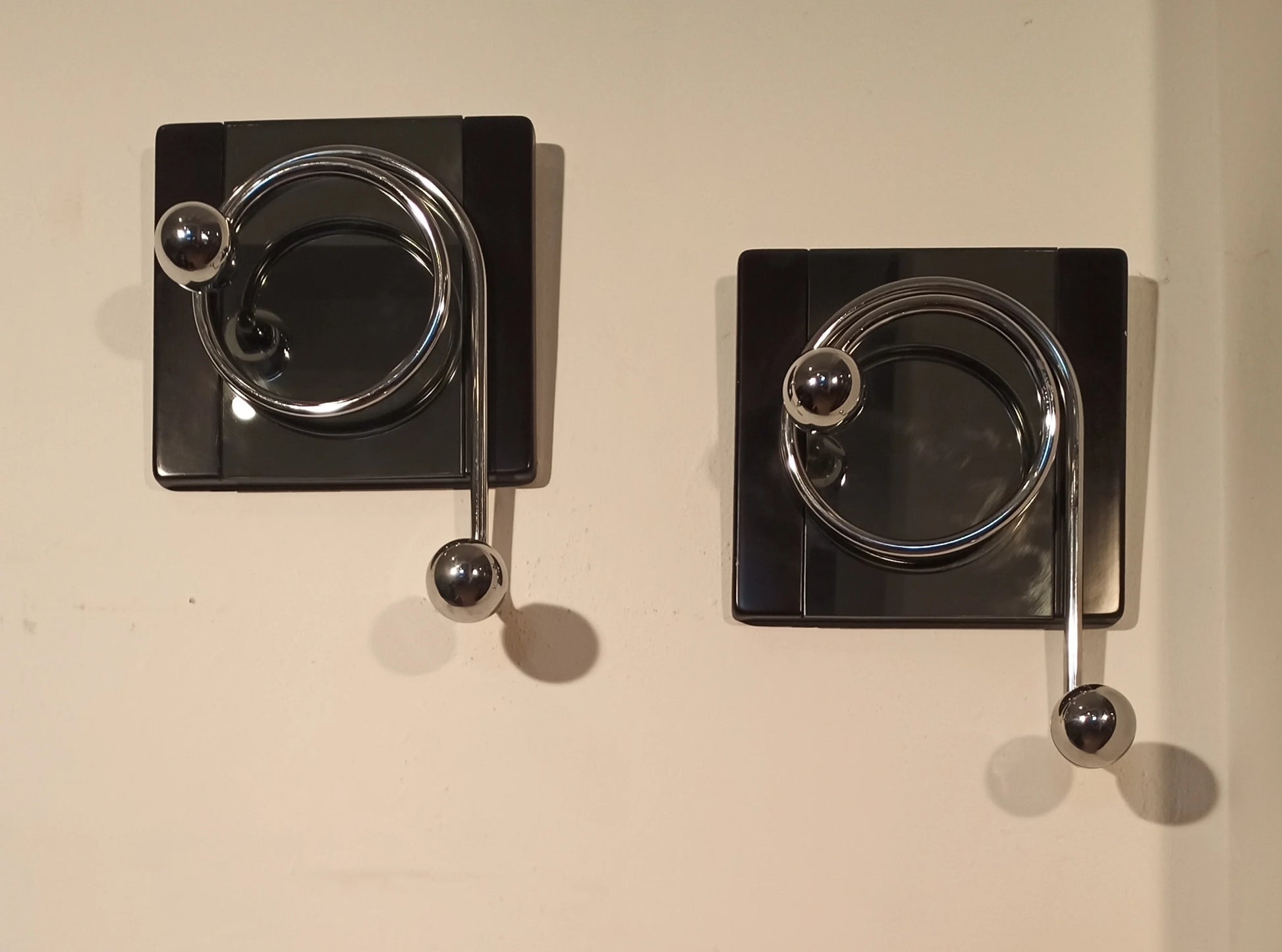 Two elegant black wall coat hooks with metal handles, designed by Willy Rizzo in the 1970s.