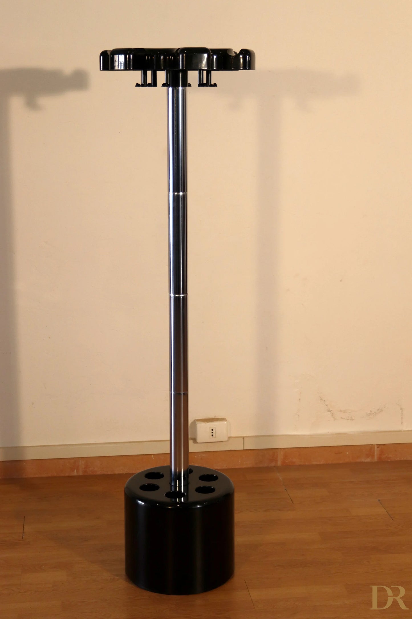 Velca coat stand by Paolo Orlandini and Roberto Lucci in black plastic and chromed metal with a circular base