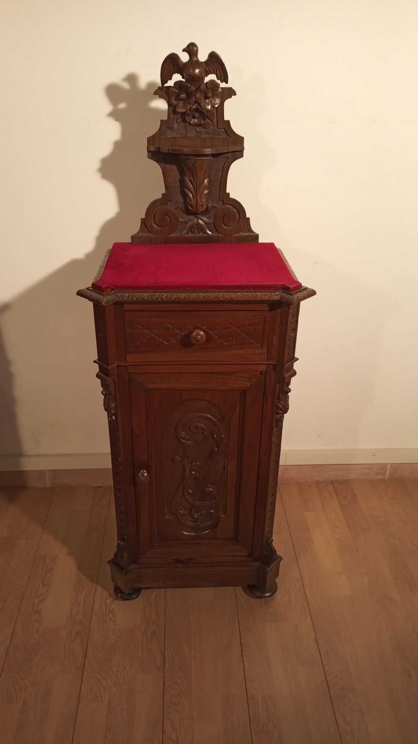 Wooden clock with red cushion above set of 3 bedside tables and chest of drawers Italian walnut 19th century