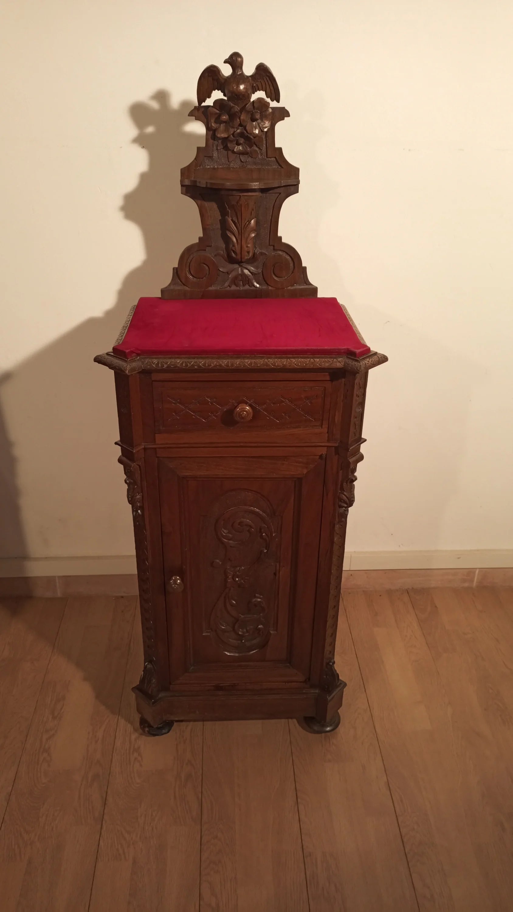 Wooden clock with red cushion above set of 3 bedside tables and chest of drawers Italian walnut 19th century