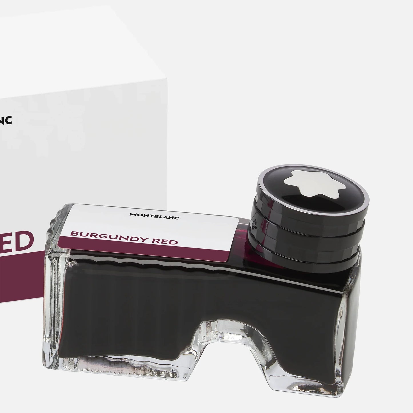 Montblanc 50ml ink bottle in elegant glass with black cap and star logo in burgundy red.