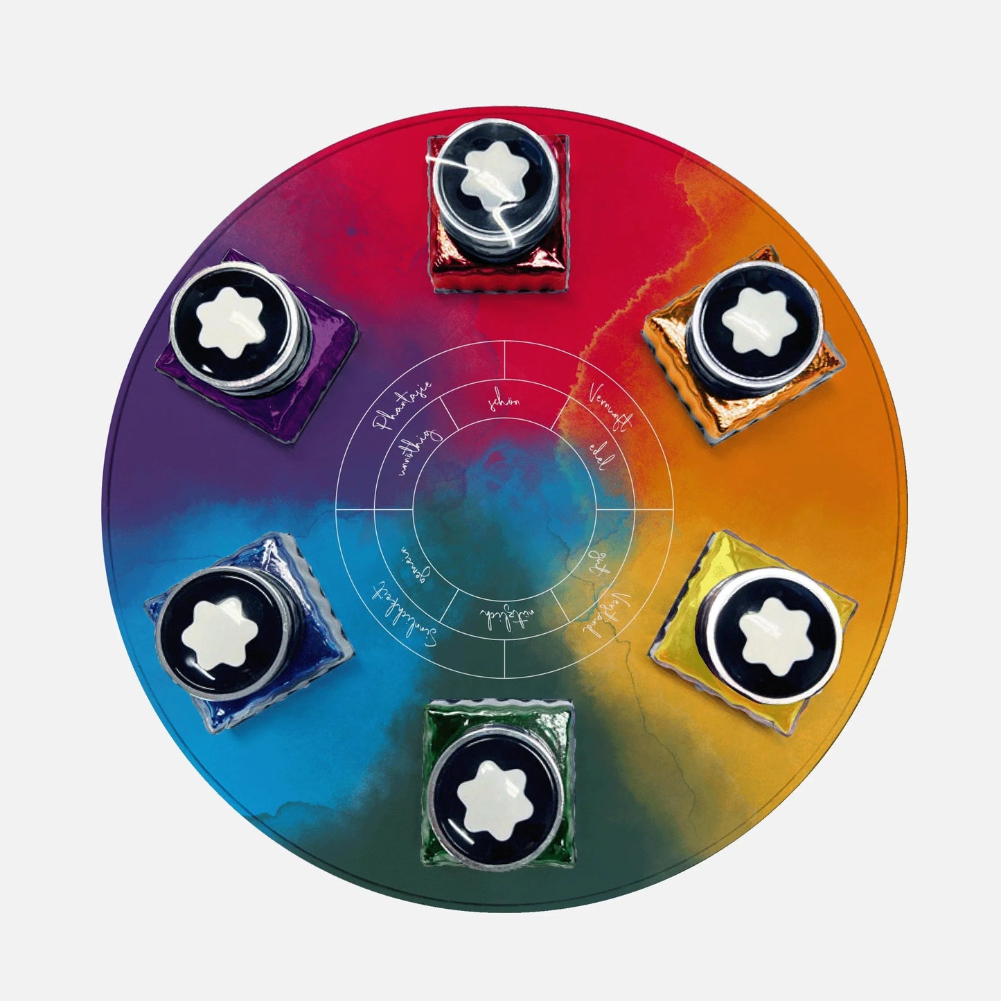 Circular tray with rainbow hues containing six bottles of Montblanc Wolfgang von Goethe 30ml ink.