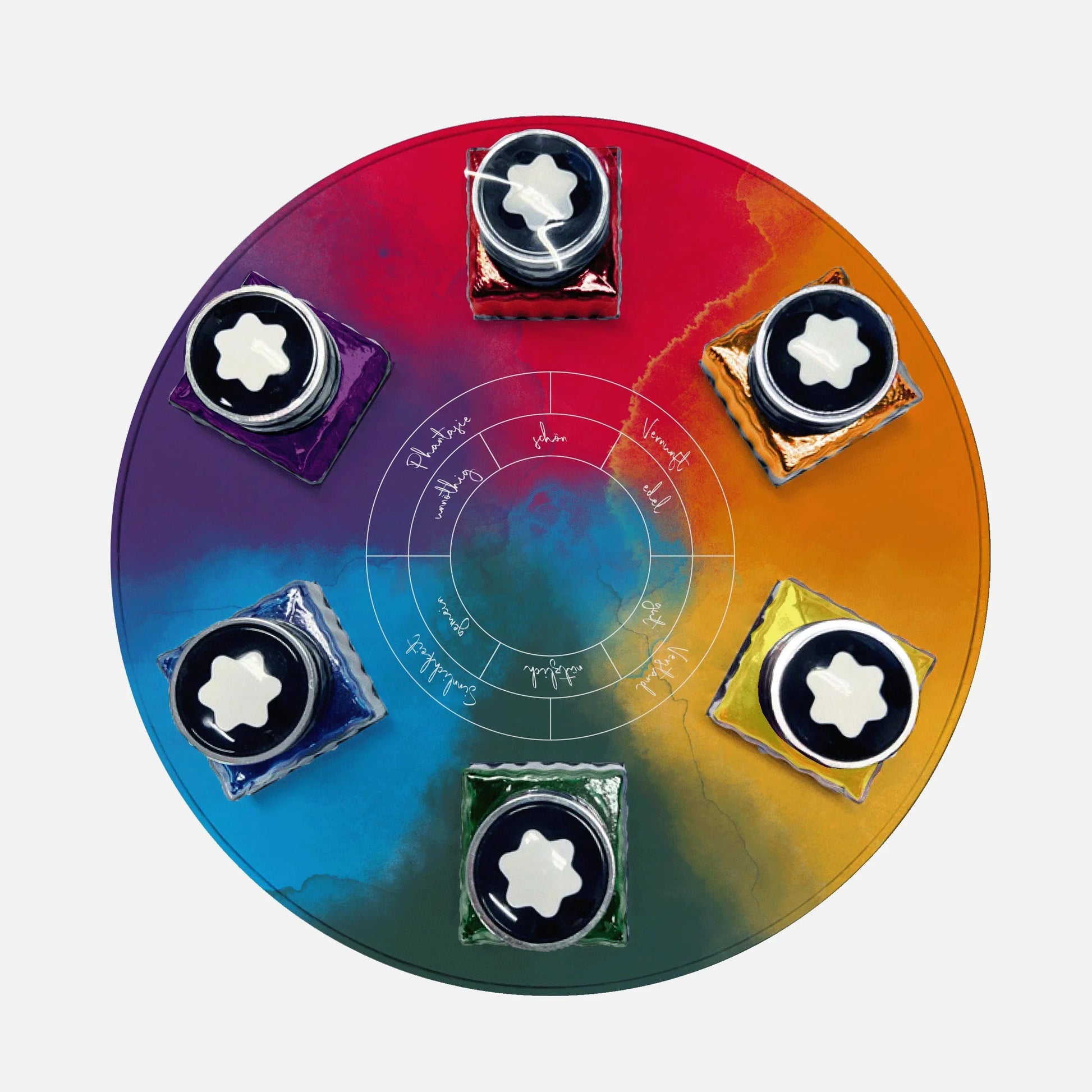 Circular tray with rainbow hues containing six bottles of Montblanc Wolfgang von Goethe 30ml ink.