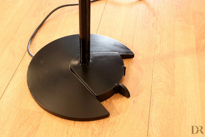 Black metal base of the Arteluce Triana floor lamp with segmented circular design by Perry King and Santiago Miranda