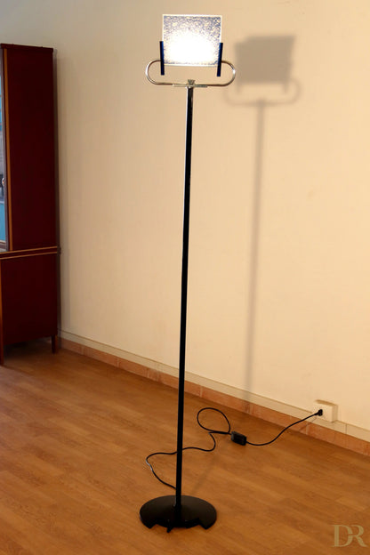 Vintage Triana floor lamp by Arteluce with black metal base and rectangular glass shade, text by Perry King and Santiago Miranda