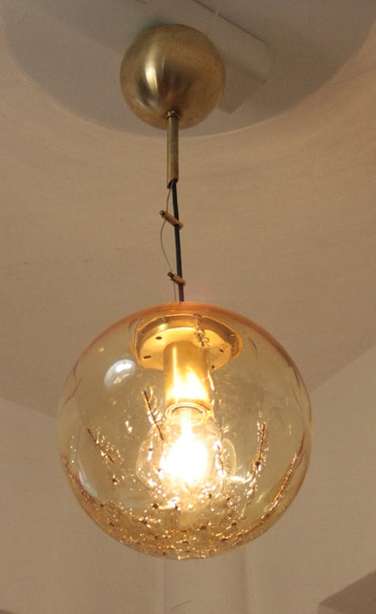 Pendant lamp with spherical pendant in amber glass and brass, signed by Italian design from the 1970s.