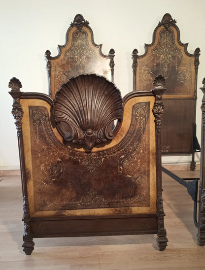 19th century Italian wrought iron bed with headboard decorated with shell motifs and carved scrolls