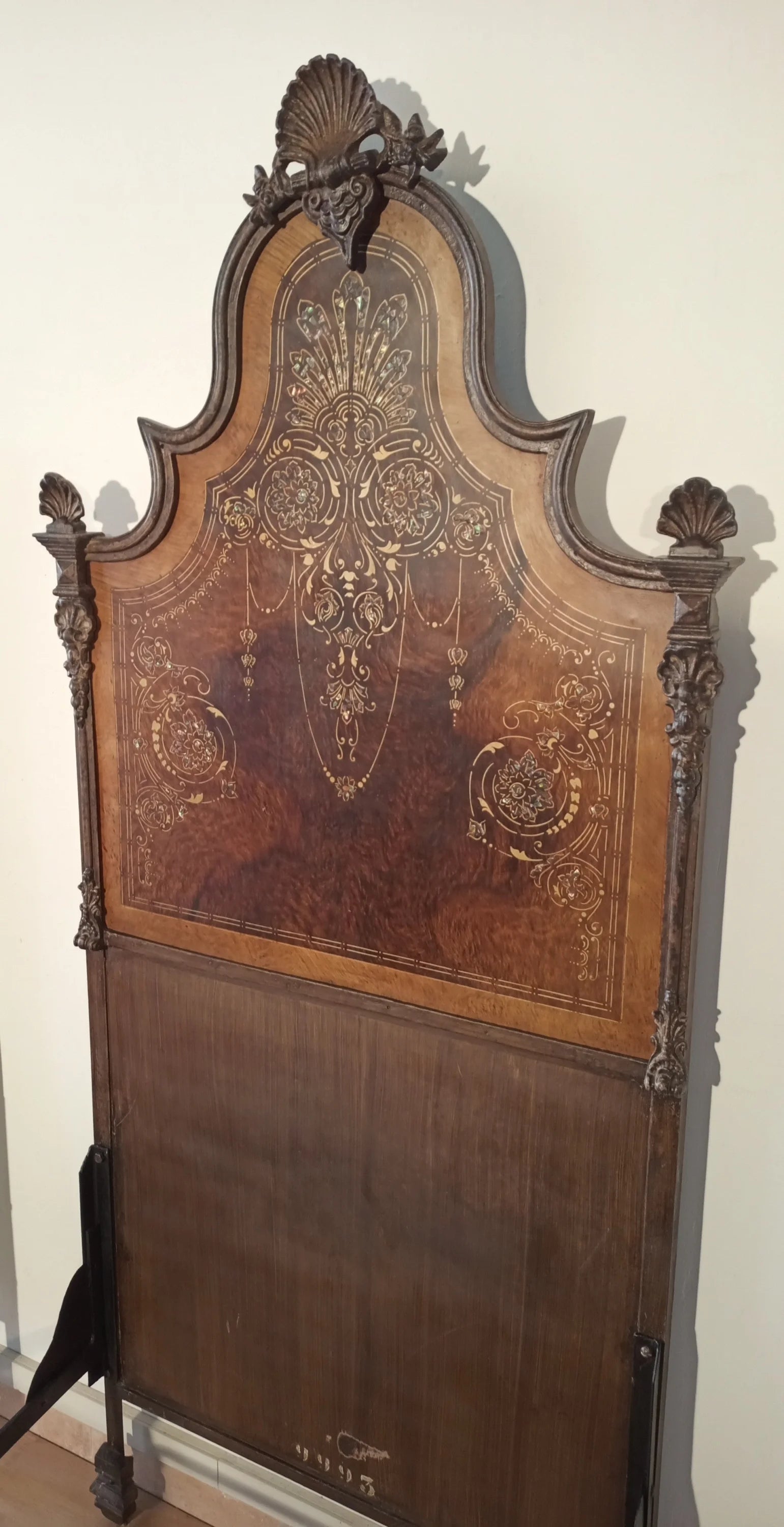 19th century Italian wrought iron bed with wooden headboard decorated with mother-of-pearl and ornamental carvings