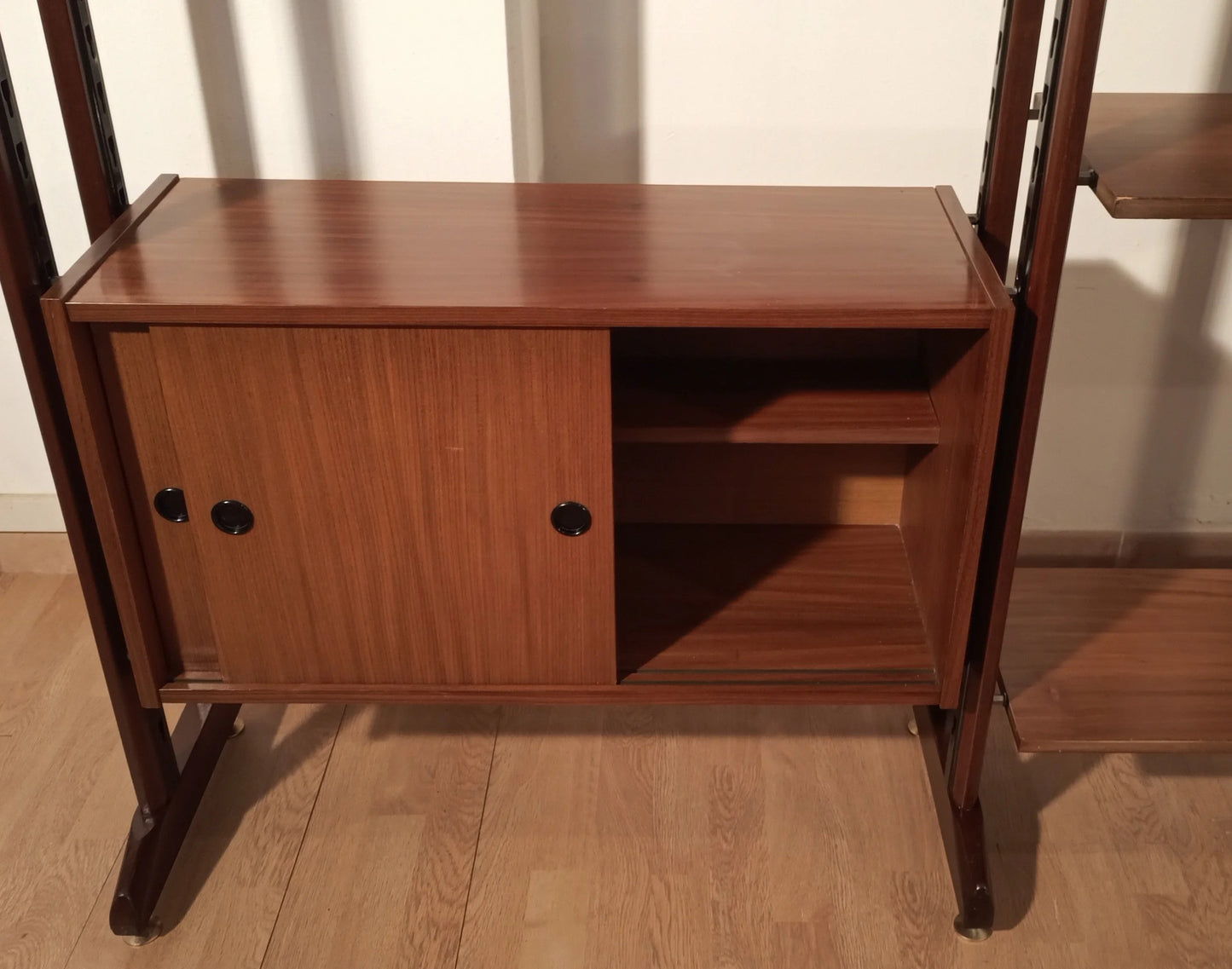 Original vintage modular teak bookcase with sliding doors and dark supports, 1960s Italy