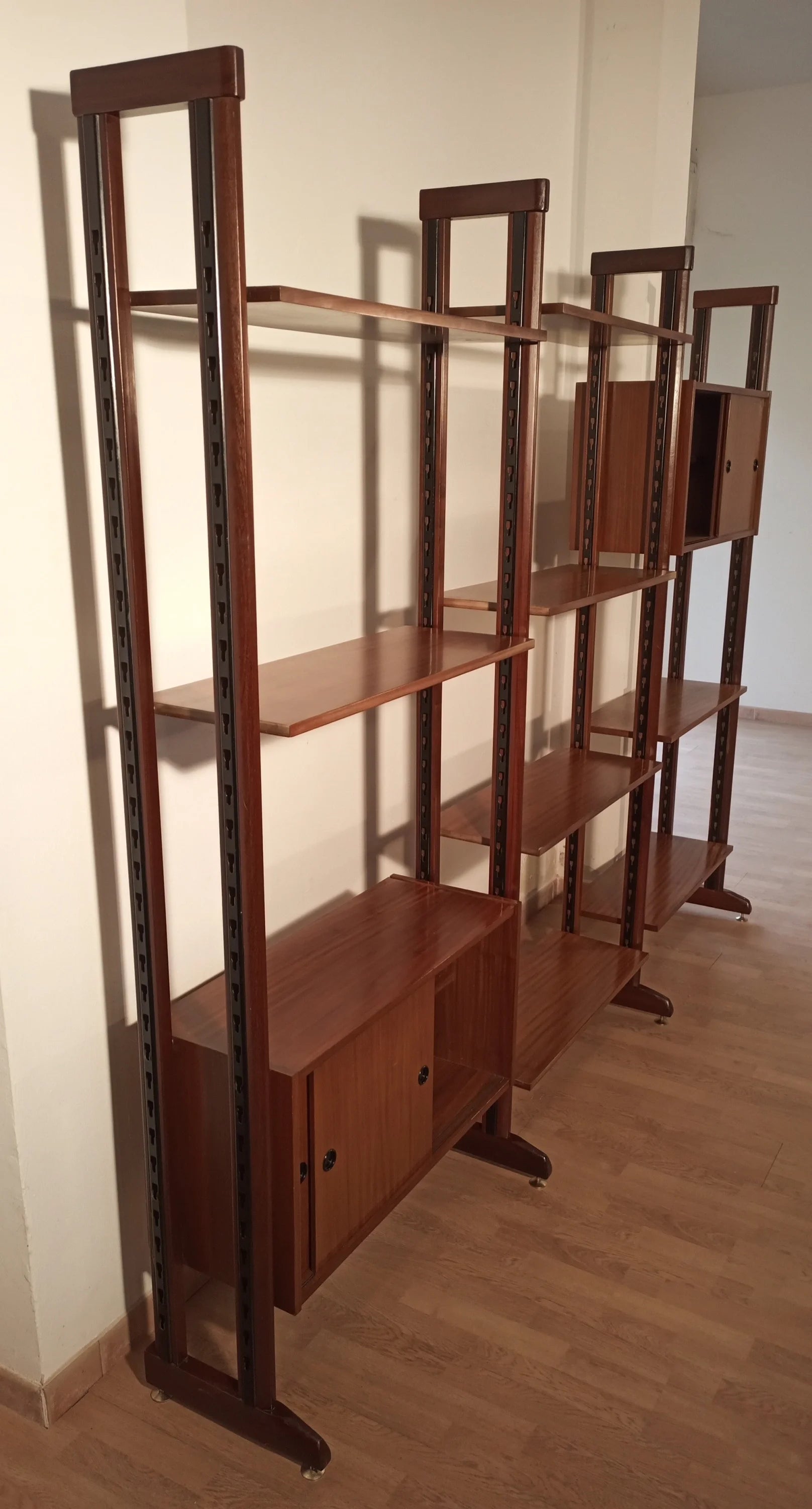 Vintage modular teak bookcase with vertical supports and door compartments, original 1960s modular bookcase