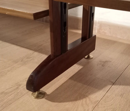 Dark wood leg with metal feet of original vintage modular teak bookcase on wooden floor