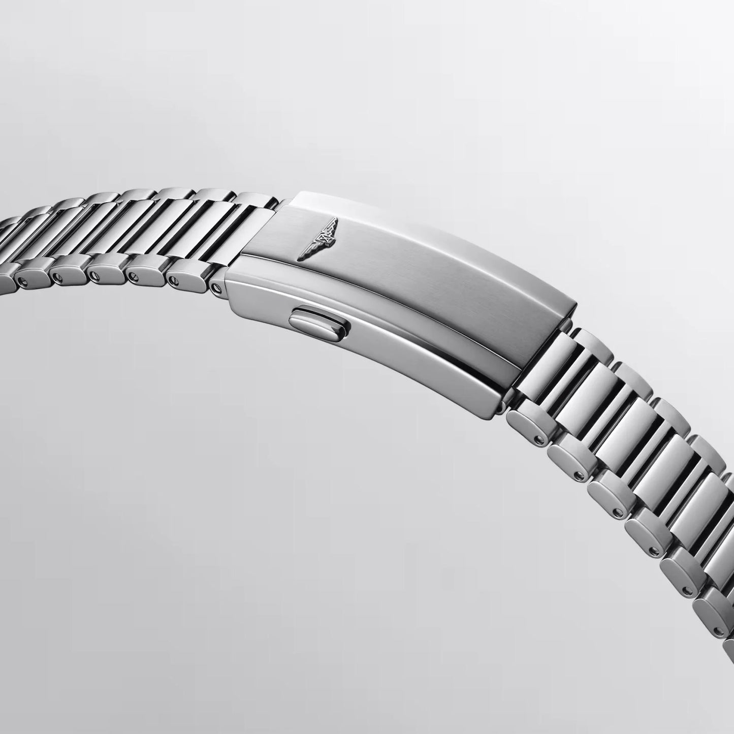 Silver tone stainless steel bracelet with interwoven polished links and Longines logo engraved in the buckle protected by the Swiss Federal Office