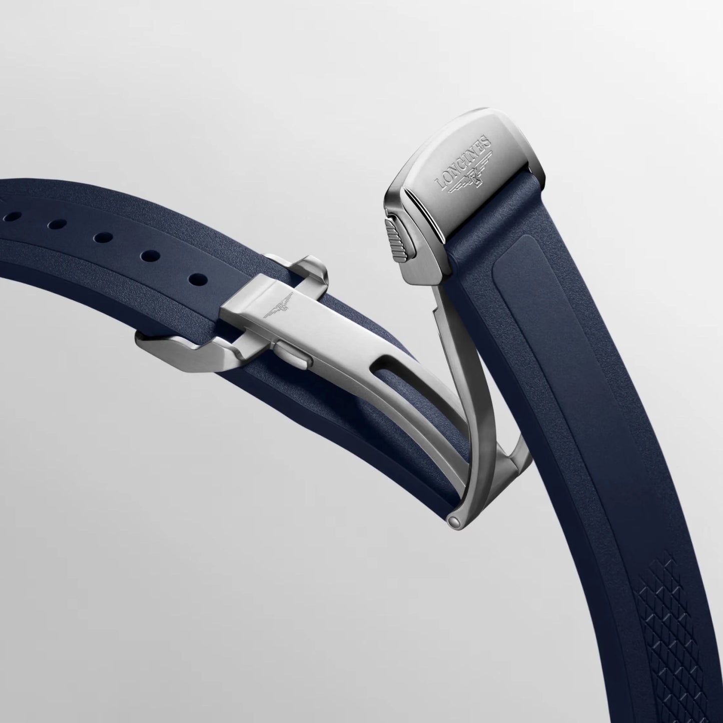 Navy blue rubber strap with silver folding clasp and textured pattern for Swiss Federal Office of Defense Conquest watch