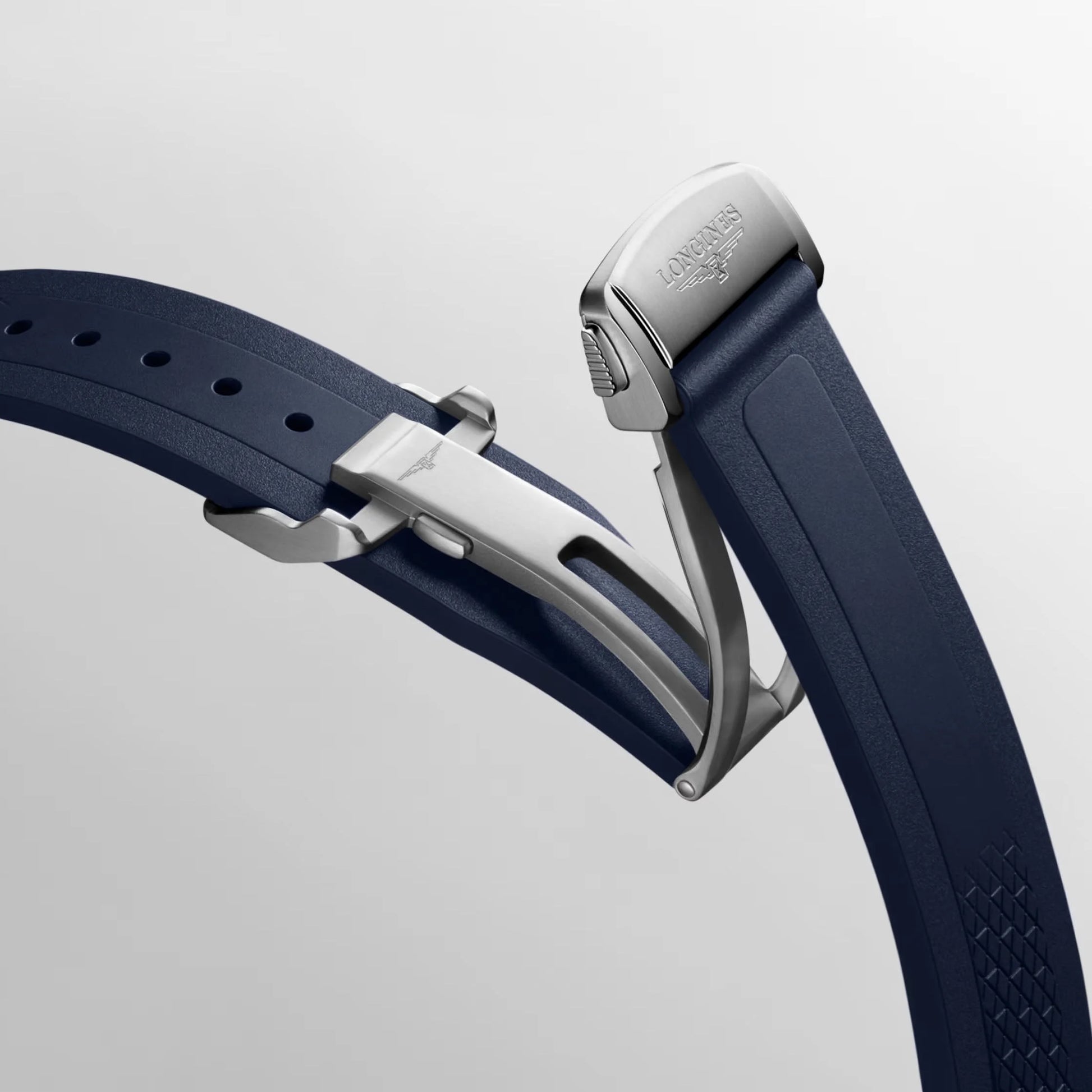 Navy blue rubber strap with silver folding clasp and textured pattern for Swiss Federal Office of Defense Conquest watch
