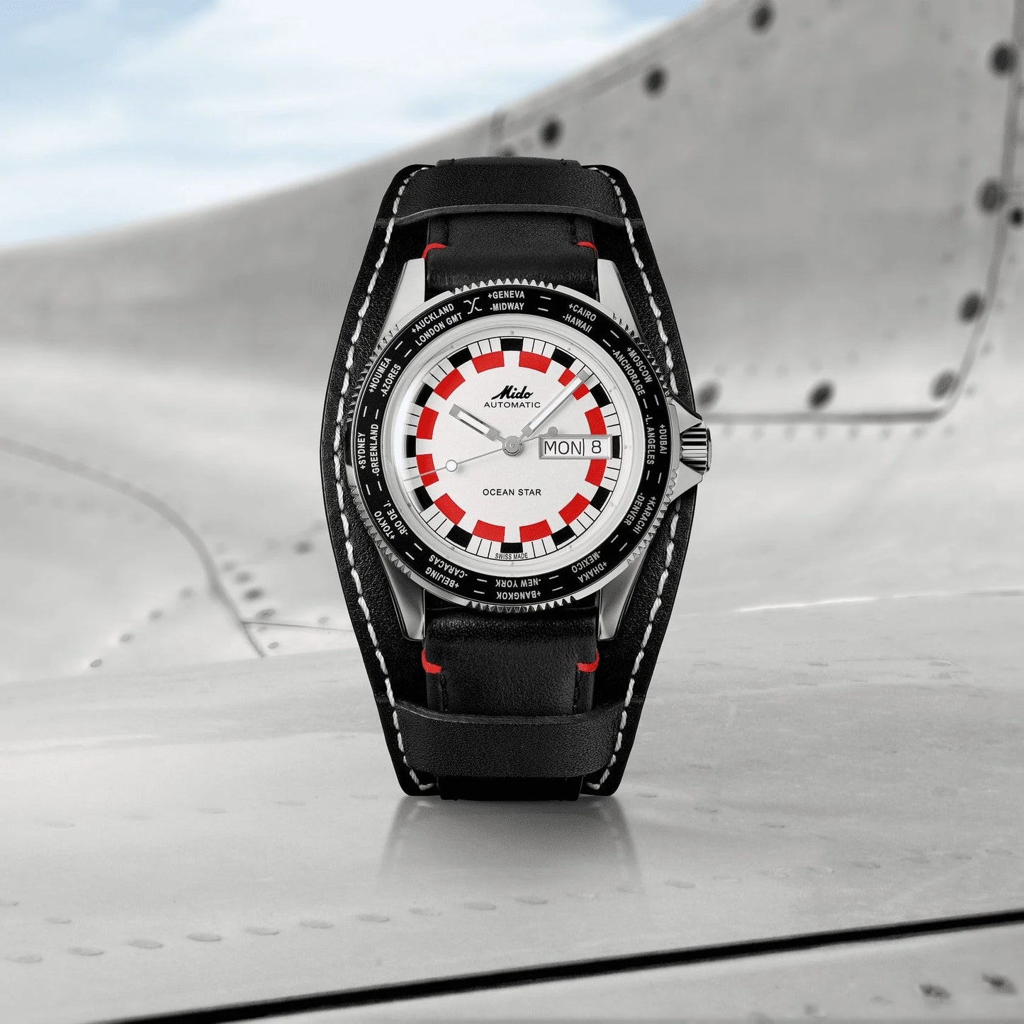 Mido Ocean Star Worldtimer 40mm watch with silver case, red and black checkered dial and black leather strap