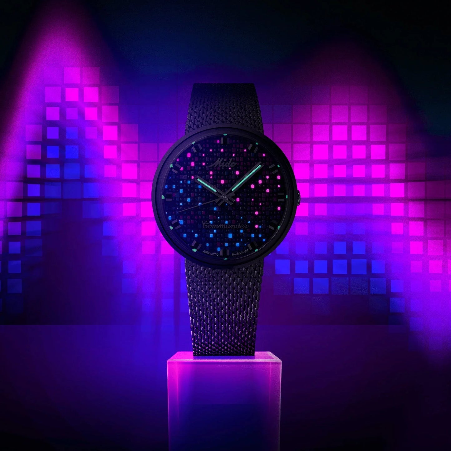 Mido Commander 1959 37mm black automatic steel watch with black dial and luminous blue and pink details, mesh strap