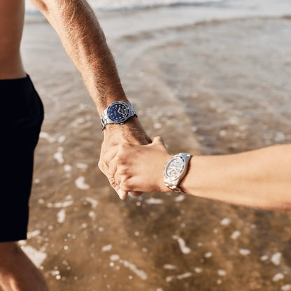 Mido Ocean Star 39mm automatic steel watch with blue dial and black markings on the left wrist