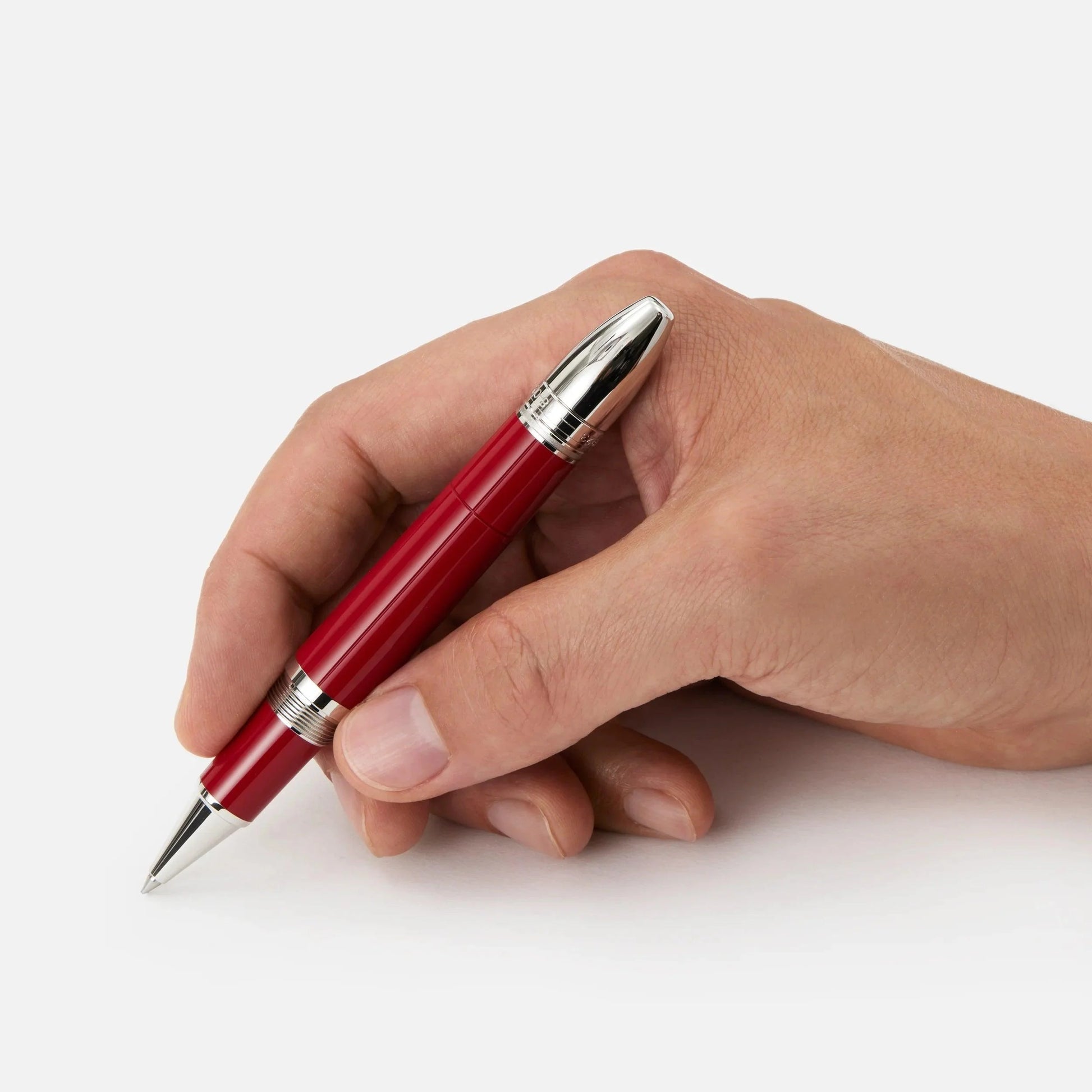 A sleek red montblanc roller pen with silver accents and metallic clip honoring enzo ferrari and scuderia ferrari