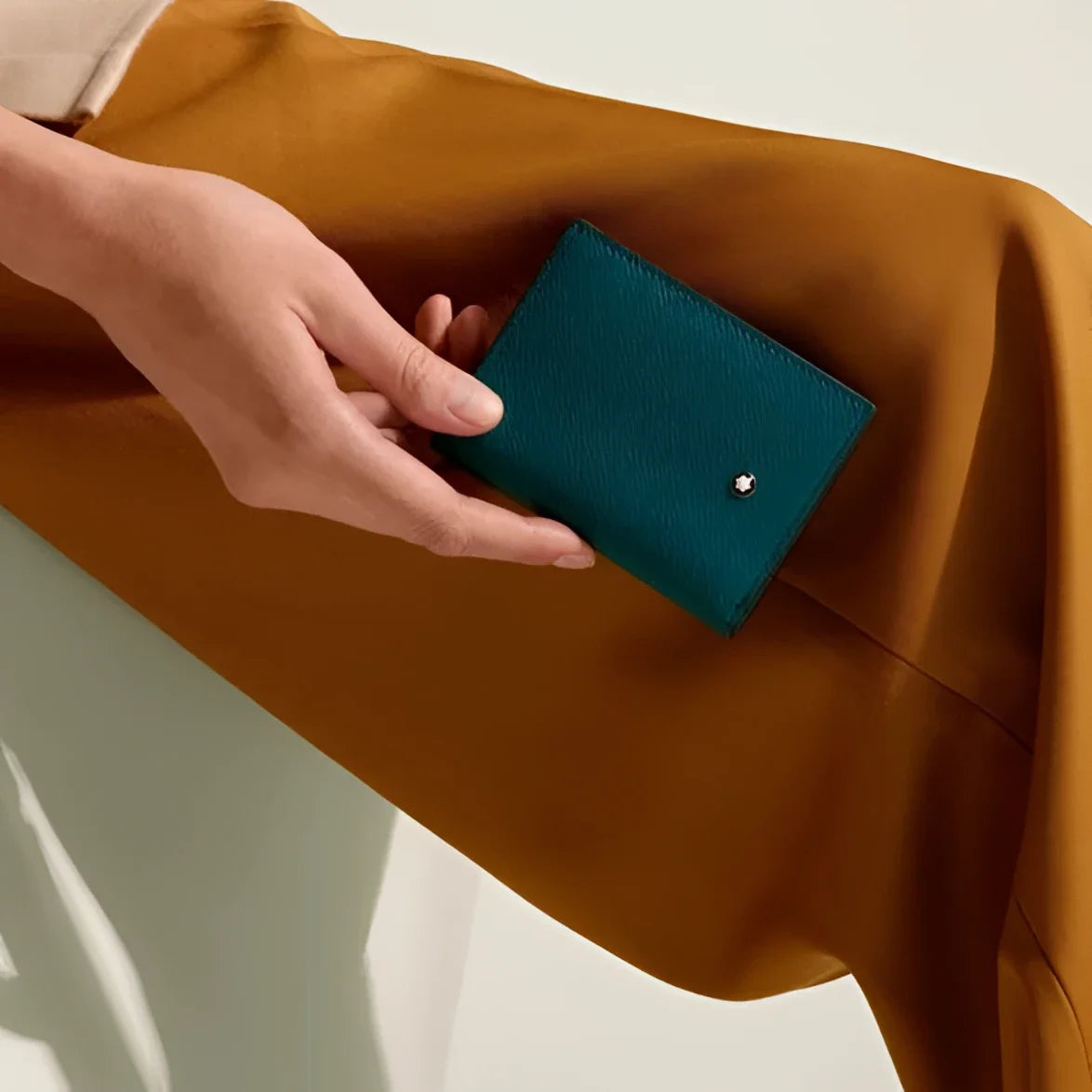 Montblanc Mini Wallet Cyprus Blue in teal leather with textured finish and small silver emblem on the front.