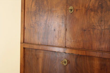 Wooden cabinet doors with brass circular handles on a splendido secretaire umberto in rovere massello fine ottocento