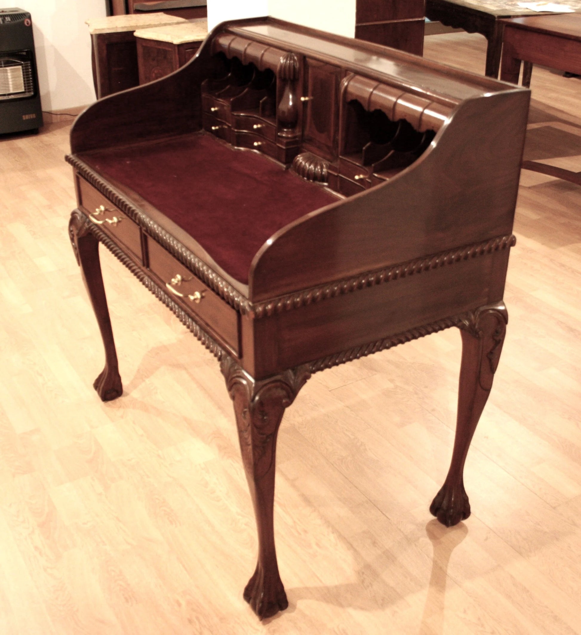Antique English Chippendale style walnut writing desk with arched legs and leather top