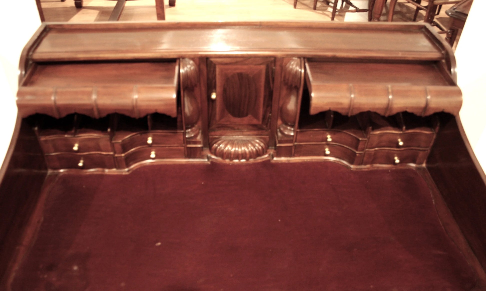 Ornate English Chippendale style walnut office desk with secretaire and arched legs decorated in wood