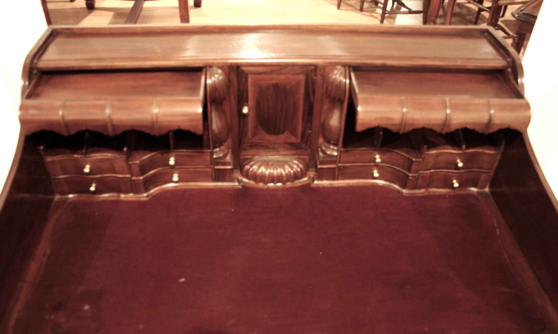Ornate English Chippendale style walnut office desk with arched legs and decorative carved details