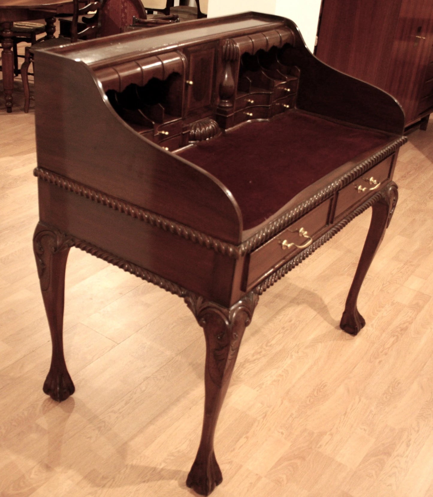 Ornate English Chippendale style walnut office desk with arched legs and decorative details