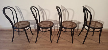 Set of 4 Thonet Italian style bent beech dining chairs with cane seats arranged in a row