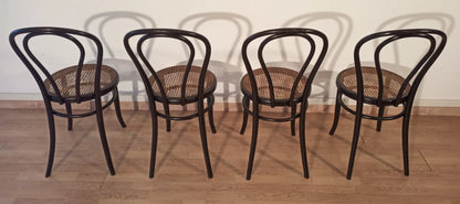 Set of 4 Thonet Italia style bentwood dining chairs with cane seats arranged in a row