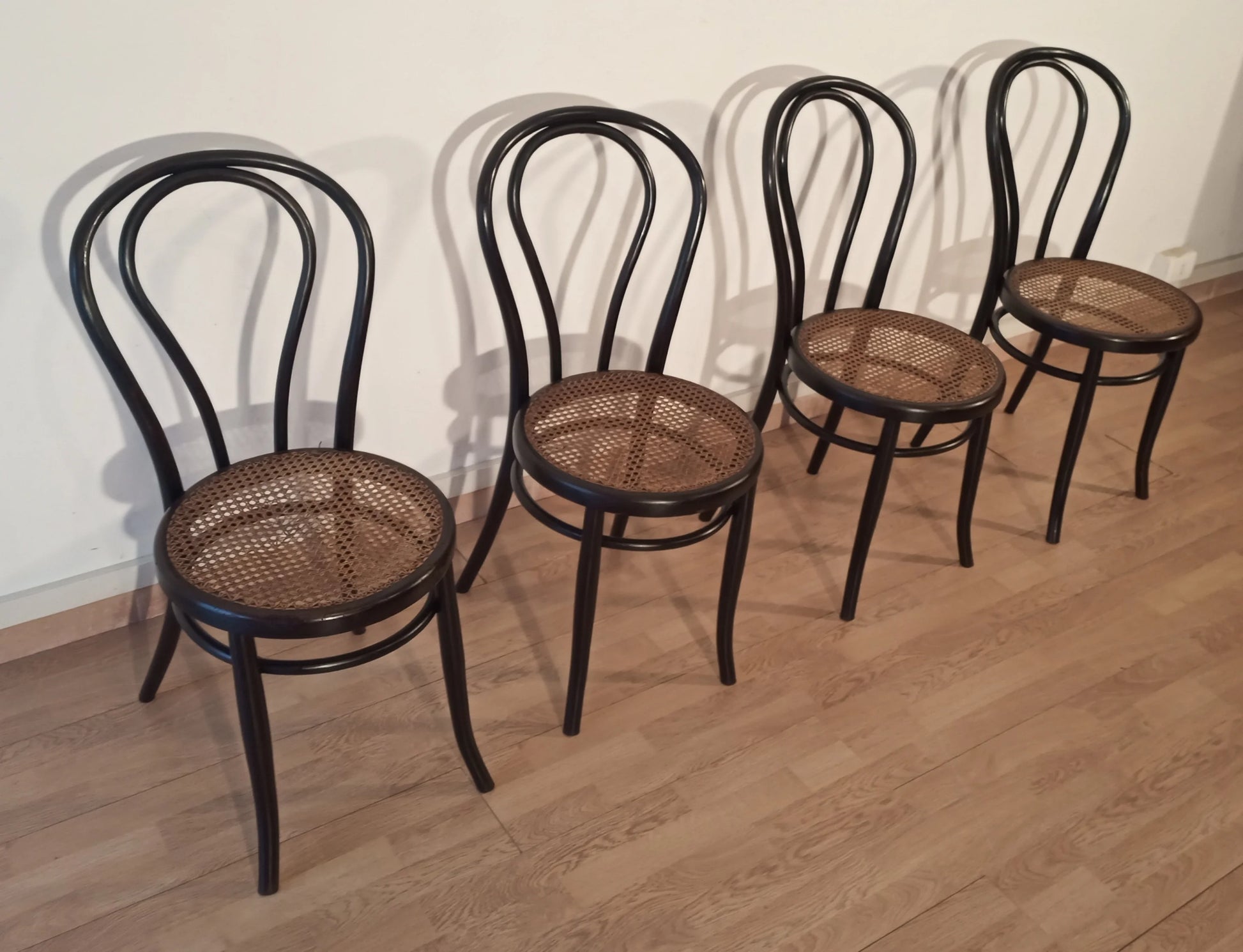 Set of 4 black bentwood dining chairs with cane seats in the Thonet Italia style