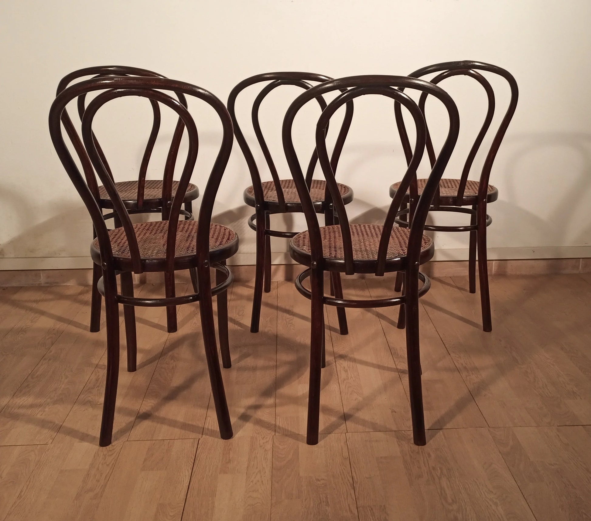 Four Thonet Drava style chairs with curved backs and inserted straw seats set of five