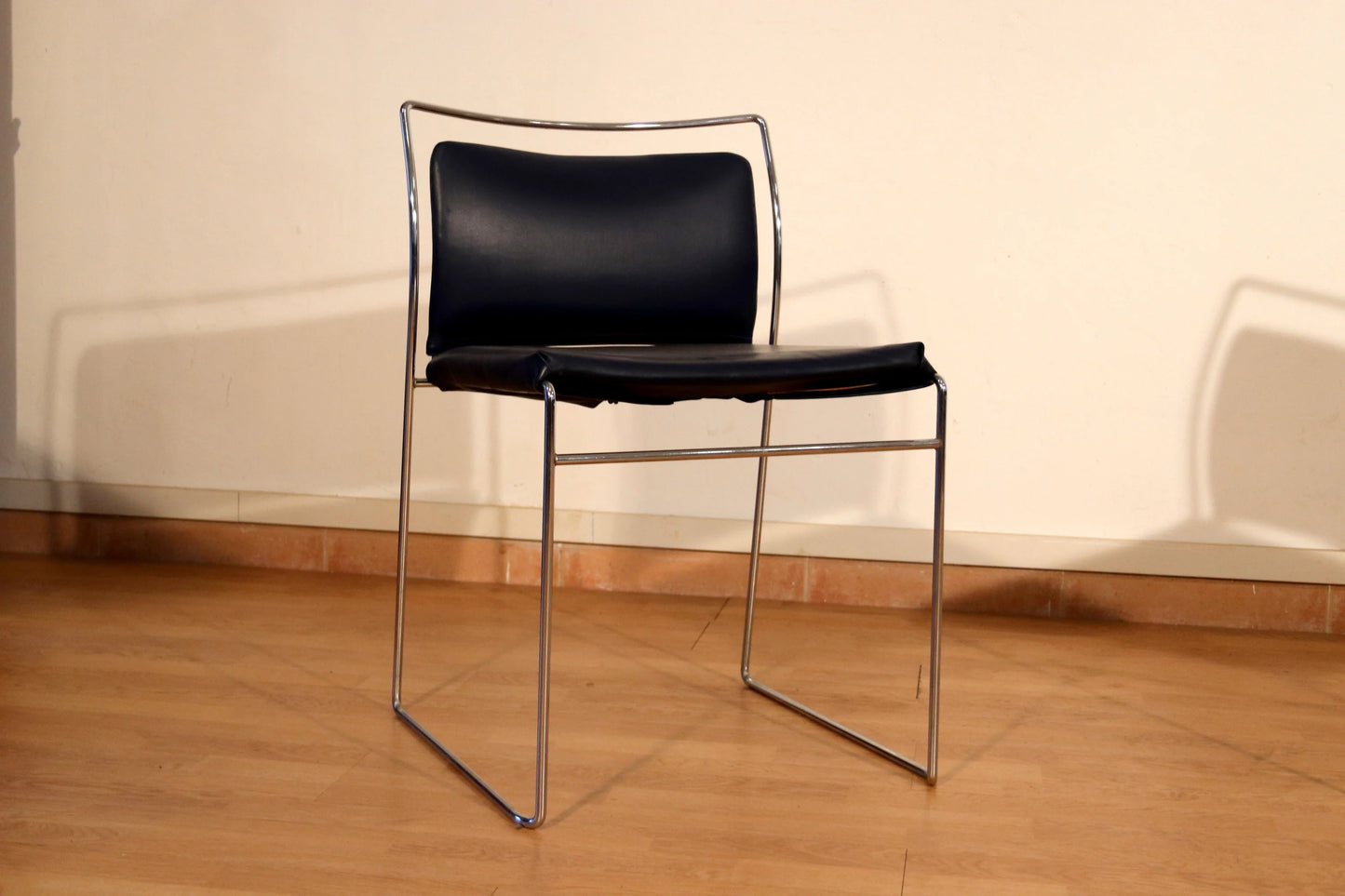 Pair of Tulu chairs by Kazuhide Takahama for Simon Gavina, 1970s, with black leather seat and backrest and chromed metal frame.