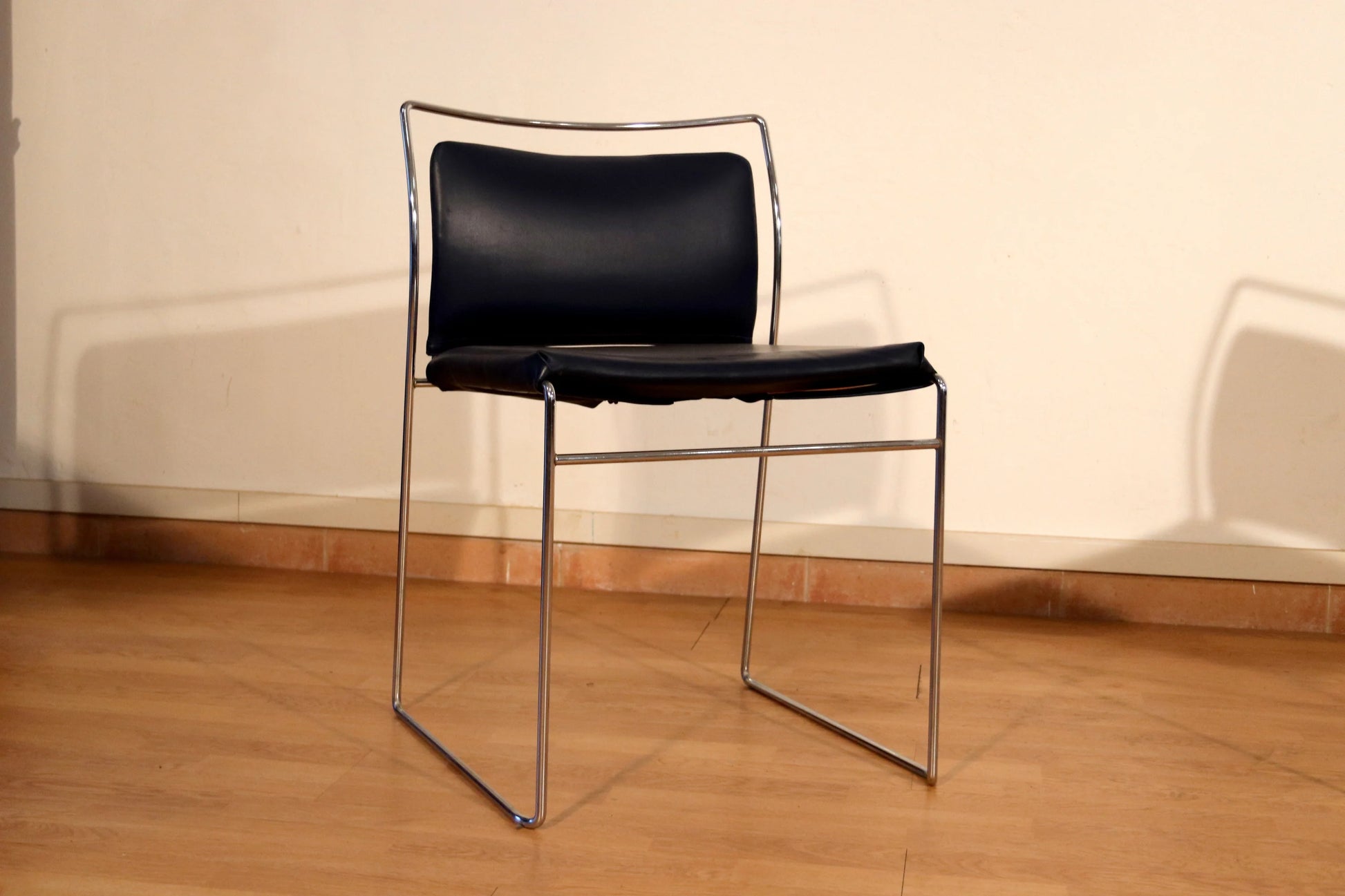 Pair of Tulu chairs by Kazuhide Takahama for Simon Gavina, 1970s, with black leather seat and backrest and chromed metal frame.