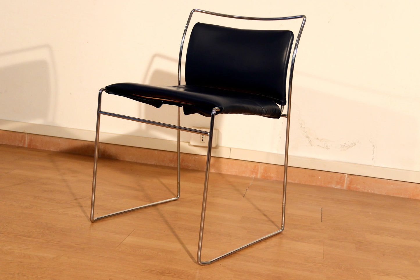 A pair of Tulu chairs by Kazuhide Takahama for Simon Gavina with black leather seats and elegant chrome frames.