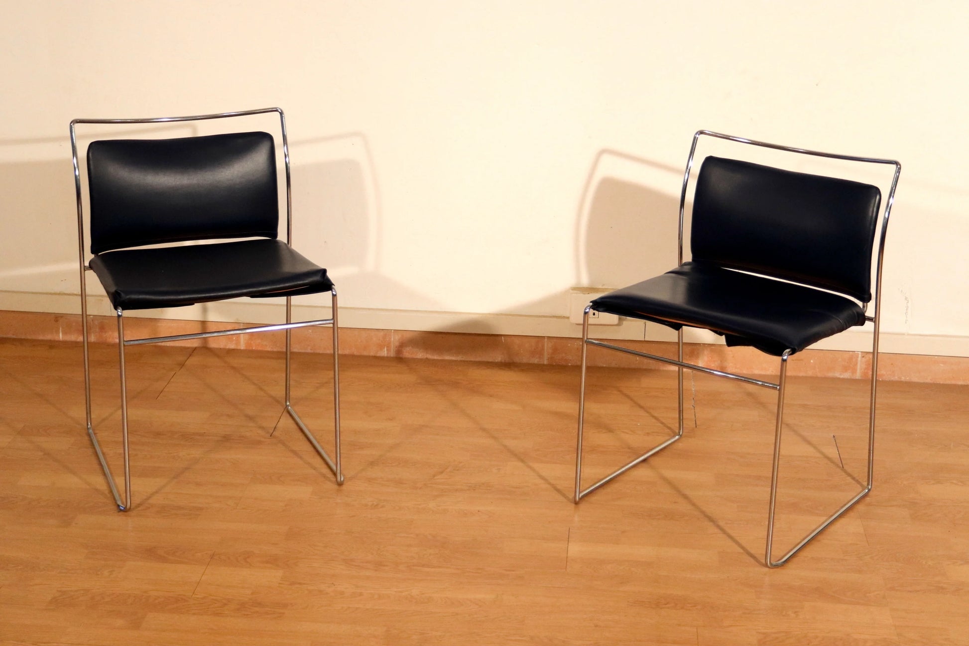 Pair of Tulu chairs by Kazuhide Takahama for Simon Gavina, 1970s, with black leather seats and chromed metal frame.