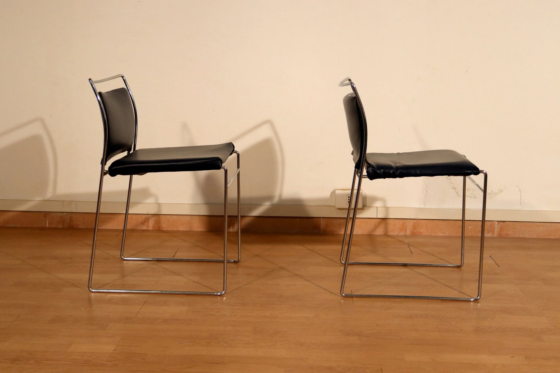 Pair of Tulu chairs by Kazuhide Takahama for Simon Gavina, 1970s, in black leather and chromed metal frame.
