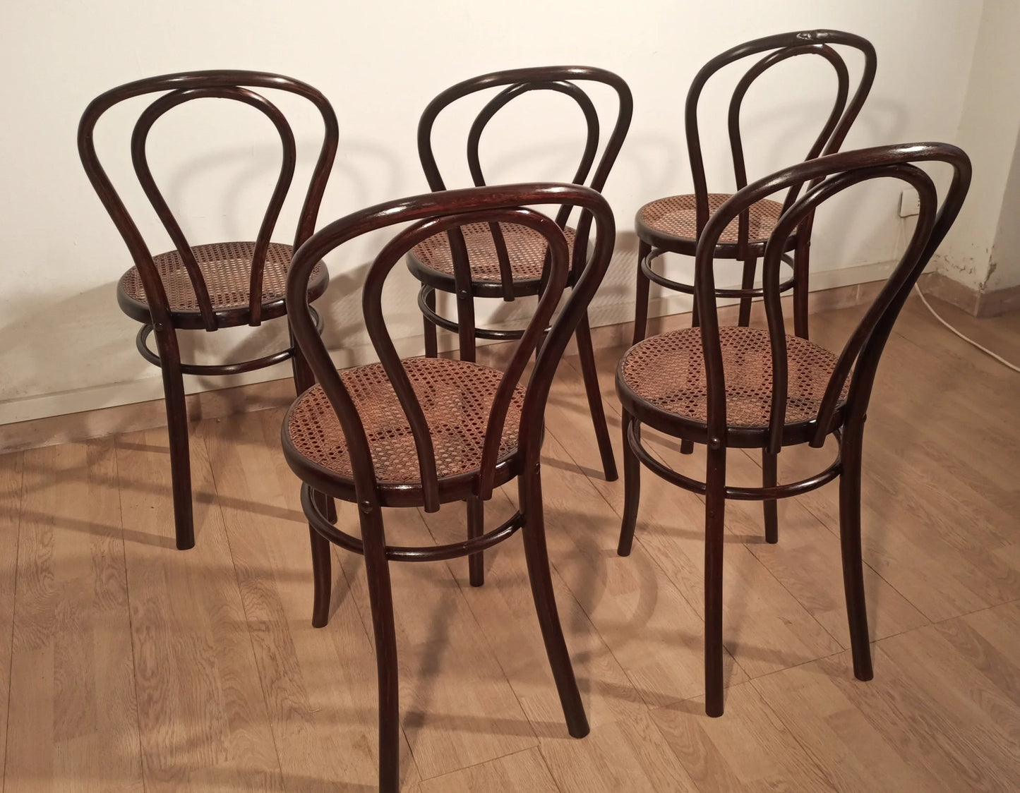 Set of five Thonet Drava style chairs with Vienna straw seats and curved bentwood backrests.