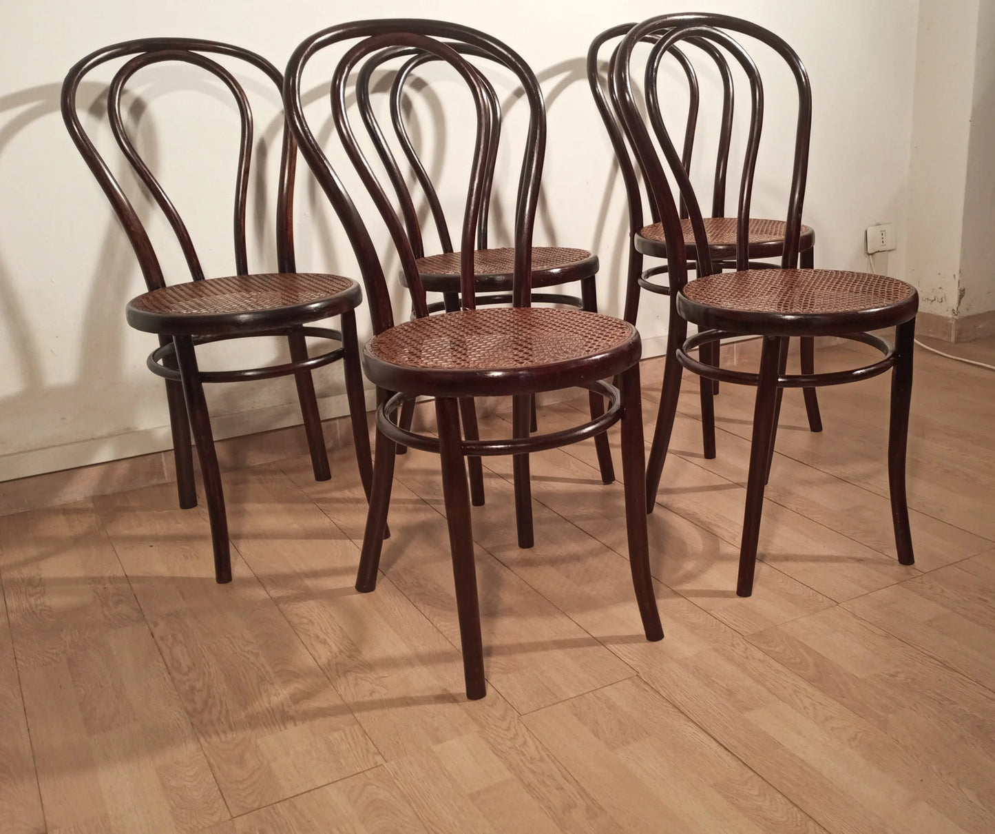 Four vintage Thonet Drava style chairs with curved backs and woven cane seats, set of 5